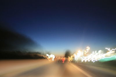 Blurred motion of car on road at night