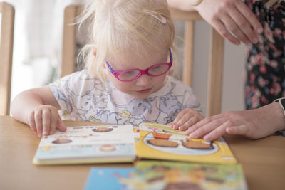 Girl drawing on table