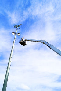 Low angle view of power lines against blue sky