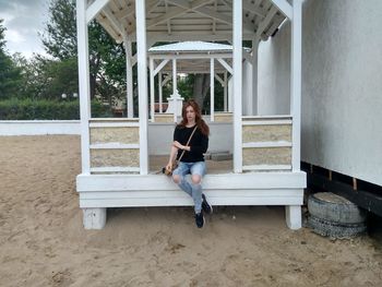 Woman sitting in gazebo at beach