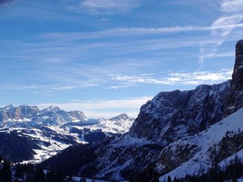 Low angle view of snowcapped mountain against cloudy sky