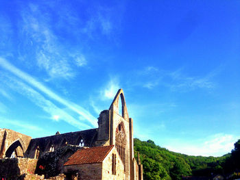 Low angle view of old building against blue sky