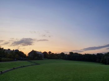 Scenic view of field against sky during sunset