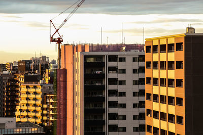 Residential buildings in city against sky