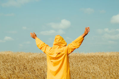 Midsection of person on field against sky