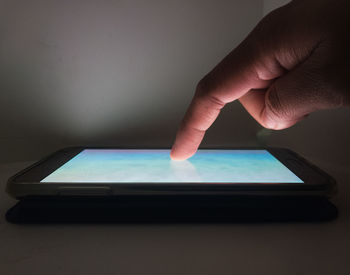 Close-up of hand touching smart phone