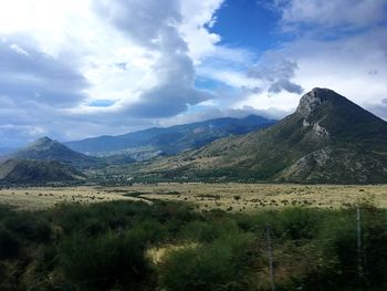 Countryside landscape against mountain range