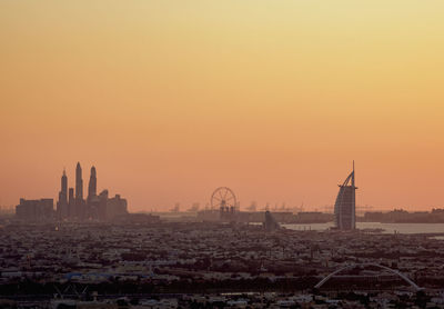 Buildings in city during sunset