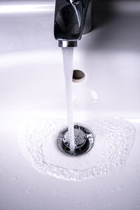 High angle view of faucet in water