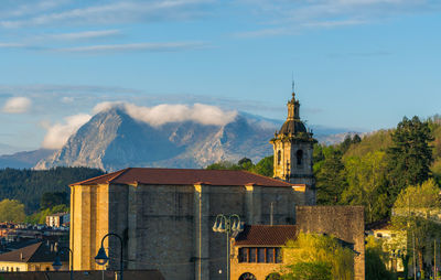 Panoramic view of building and mountains against sky