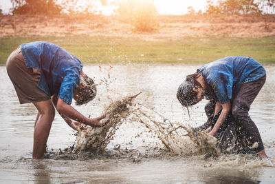 Man carrying water splashing