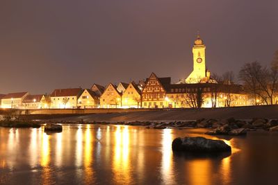 Illuminated buildings against sky at night