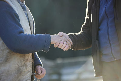 Midsection of man holding hands