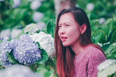 Portrait of woman with pink flower