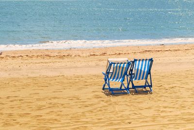 Scenic view of beach against blue sky