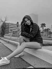 Portrait of young woman sitting outdoors