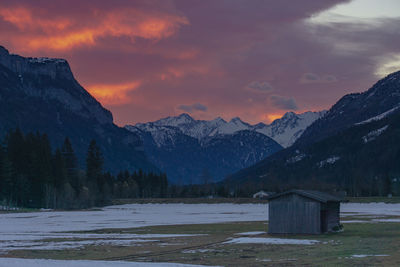 Scenic view of snowcapped mountains against sky during sunset