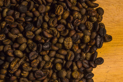 Close-up of roasted coffee beans on cutting board