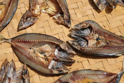 High angle view of dried fish on wicker plate