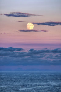 Scenic view of sea against romantic sky at sunset