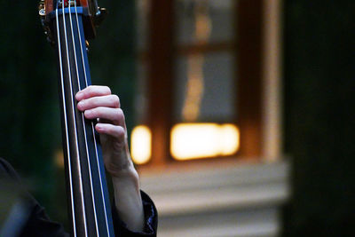 Close-up of hand playing string instrument