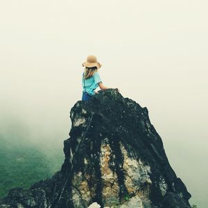 Full length of woman standing on rock