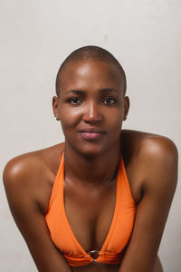 Portrait of a smiling young woman against white background