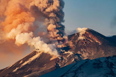 Aerial view of volcanic mountain against sky