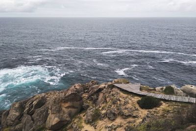 High angle view of rocks in sea against sky