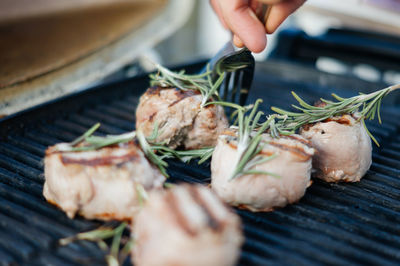 Grilled meat with rosemary on top while being prepared
