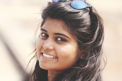 Close-up portrait of smiling young woman