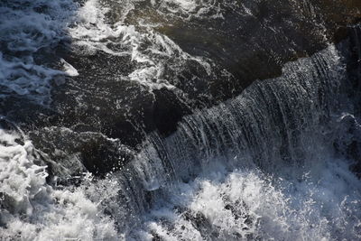 High angle view of water flowing through rocks