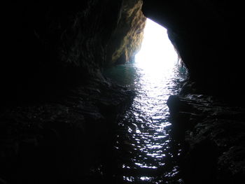 Rock formation in sea against sky