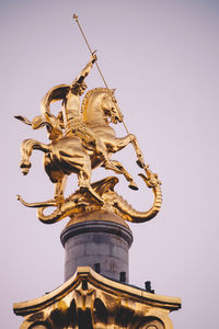 Low angle view of statue against sky