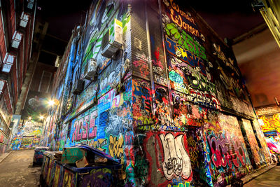 Graffiti on wall in city at night