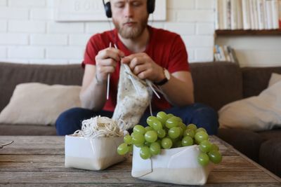 Man knitting at home