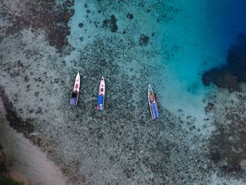 High angle view of people kayaking in sea