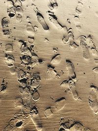 High angle view of footprints on sand