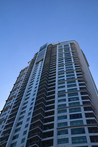 Low angle view of modern building against clear blue sky