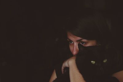 Portrait of a beautiful young woman over black background