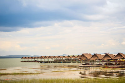 Scenic view of lake by building against sky