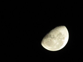 Low angle view of moon against clear sky at night