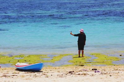 Rear view of man standing on beach