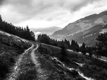 Road by mountain against sky