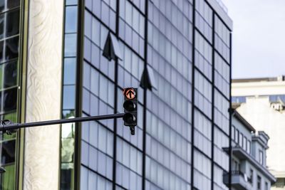 Low angle view of sign on glass building