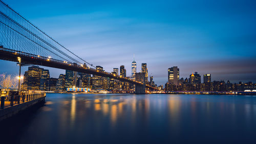 Night panorama of brooklyn bridge and lower manhattan skyline, one world trade center, dumbo, nyc