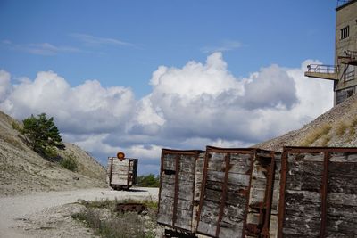 Old wooden crates against cloudy sky