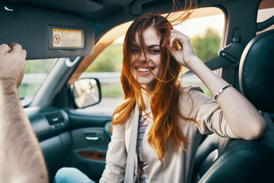 Portrait of happy woman sitting in car