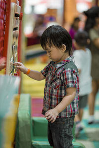 Side view of boy looking at camera