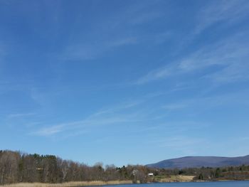 Scenic view of mountains against blue sky